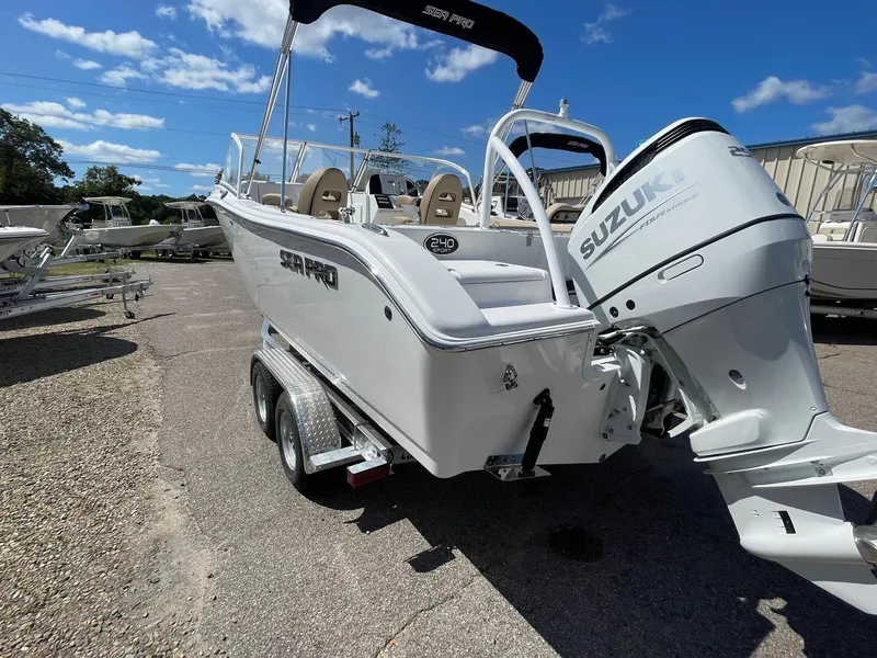 Slide: The Image of 2024 Sea Pro 240 DC Sport boat with Suzuki outboard motor on trailer. - 1