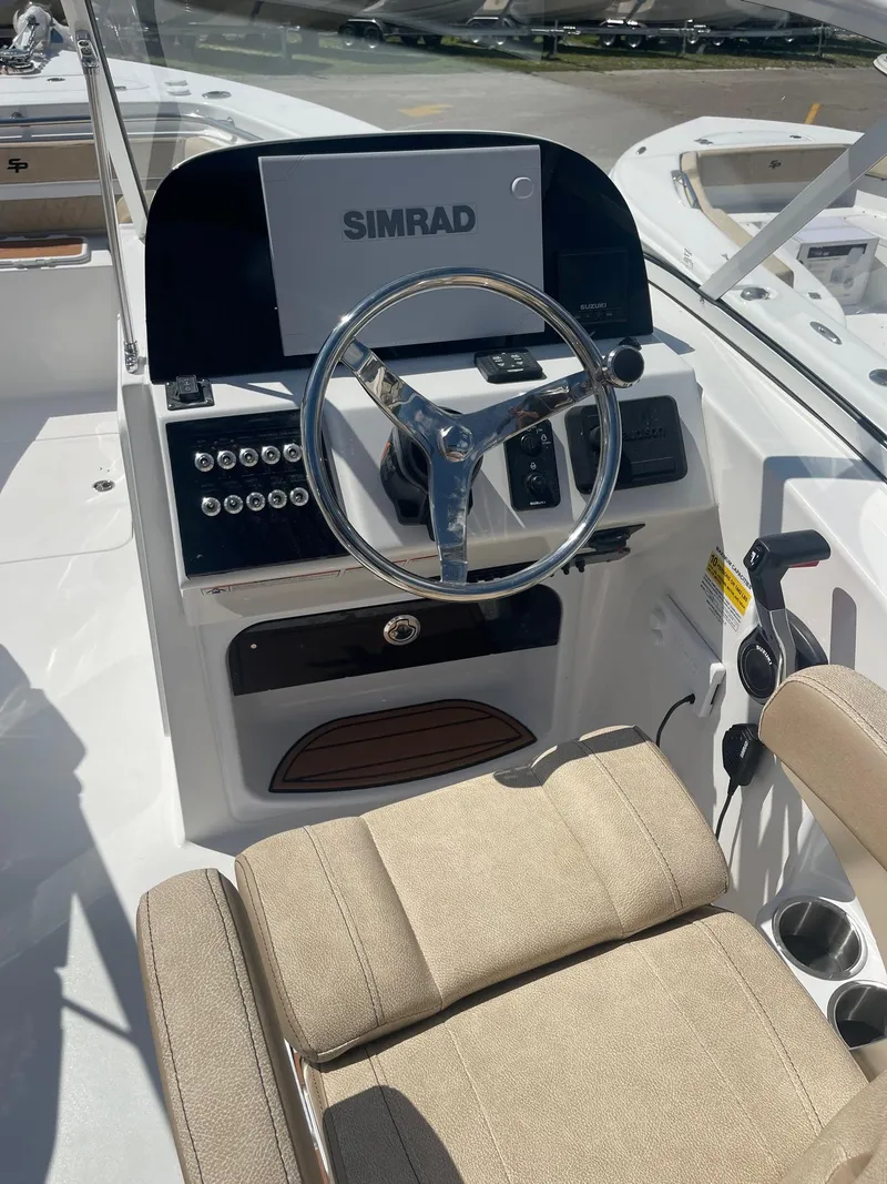 Slide: The Image of 2024 Sea Pro 240 DC Sport boat helm with Simrad display. - 10