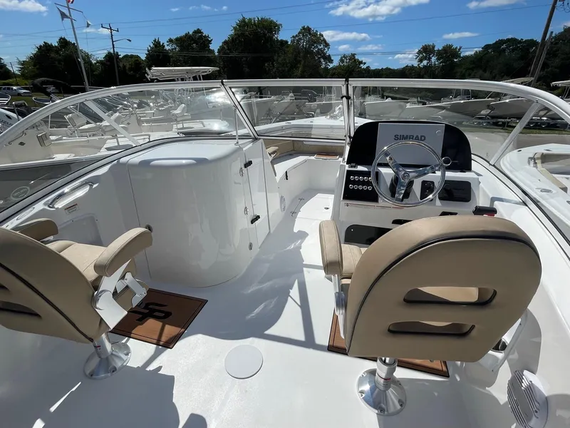 Slide: The Image of 2024 Sea Pro 240 DC Sport boat interior with dual captain chairs and modern dashboard. - 3