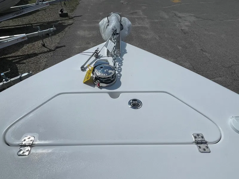 Slide: The Image of 2024 Sea Pro 240 DC Sport boat bow with anchor and storage compartment. - 4