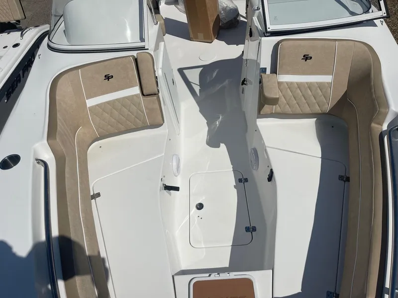 Slide: The Image of 2024 Sea Pro 240 DC Sport boat interior with beige seating and white deck. - 6