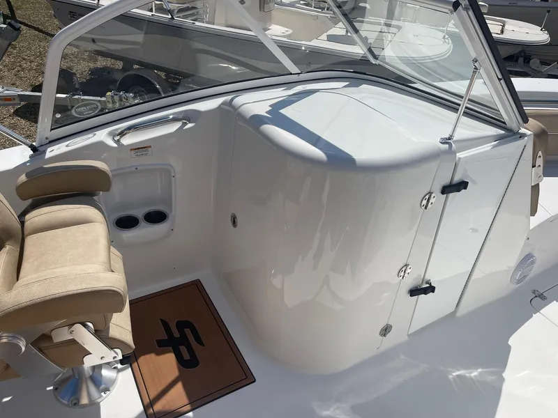 Slide: The Image of 2024 Sea Pro 240 DC Sport boat interior with seating and storage. - 8