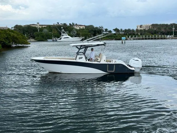 Slide: The Image of 2017 Sea Fox 288 Commander boat cruising on a calm waterway. - 2