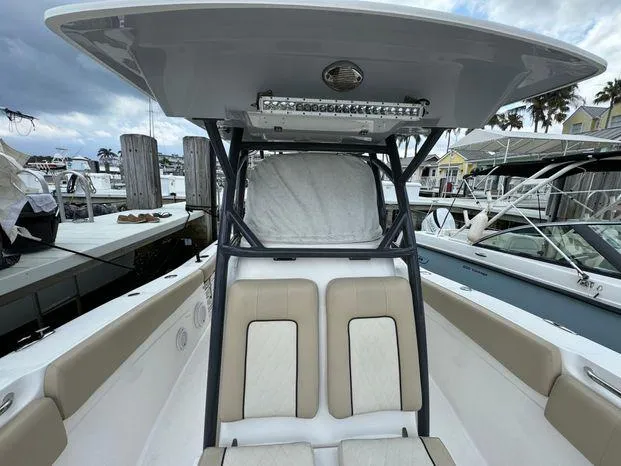 Slide: The Image of 2017 Sea Fox 288 Commander boat interior with seating and T-top at marina. - 26