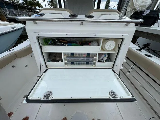 Slide: The Image of 2017 Sea Fox 288 Commander boat storage compartment with open hatch, revealing organized shelves. - 28