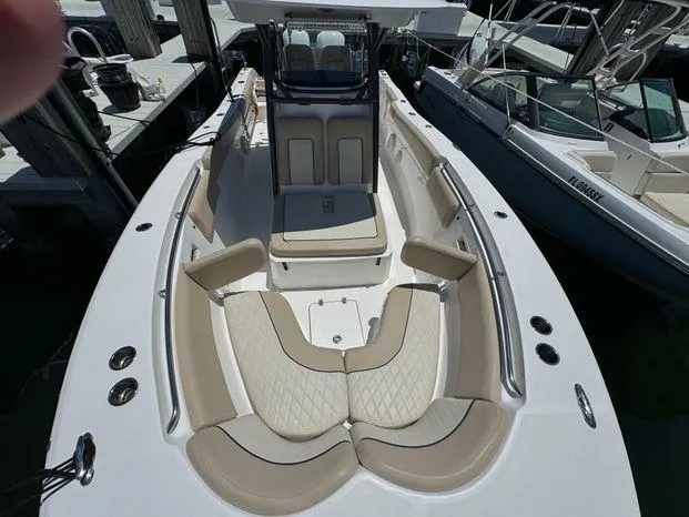 Slide: The Image of 2017 Sea Fox 288 Commander boat with spacious seating and sleek design at a marina. - 35