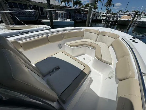 Slide: The Image of 2017 Sea Fox 288 Commander boat interior with beige seating, docked at marina. - 37