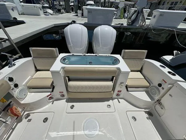 Slide: The Image of 2017 Sea Fox 288 Commander boat interior with seating and dual engines at dock. - 40