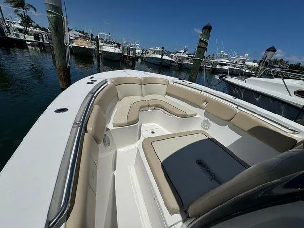 Slide: The Image of 2017 Sea Fox 288 Commander boat with spacious seating, docked in a marina under clear skies. - 46