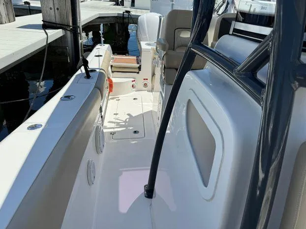 Slide: The Image of 2017 Sea Fox 288 Commander boat interior with seating and console, docked at marina. - 49