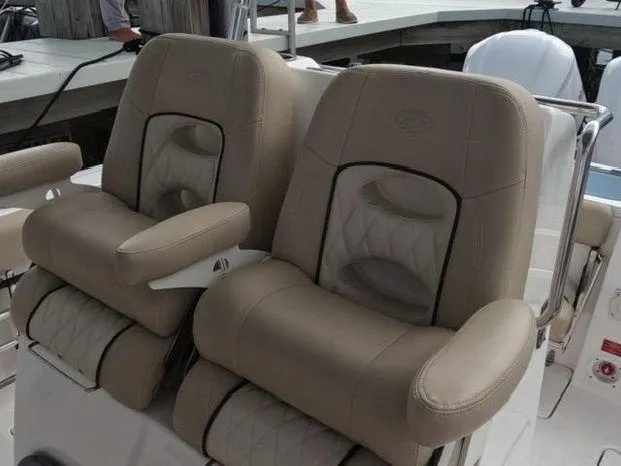 Slide: The Image of 2017 Sea Fox 288 Commander boat seats, beige leather, dual armrests, docked setting. - 5