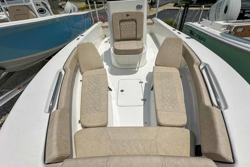 Slide: The Image of 2024 Sea Pro 202 Center Console boat interior with beige seating and white deck. - 10