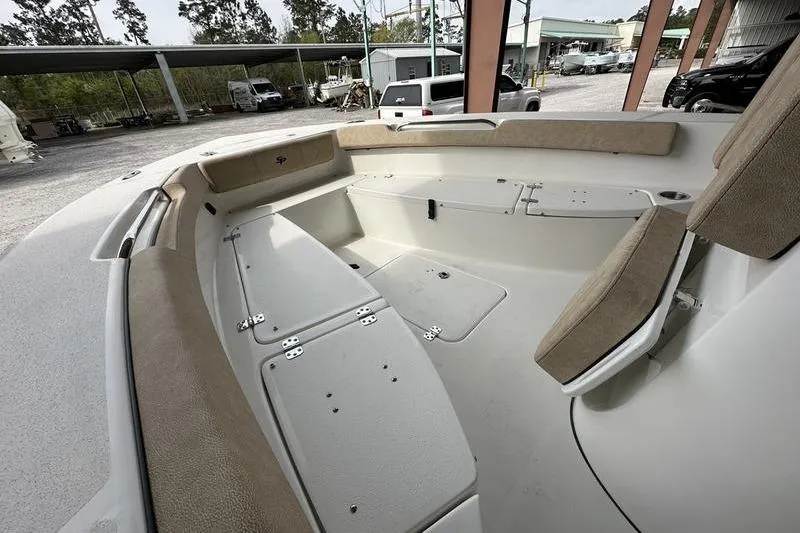Slide: The Image of 2024 Sea Pro 202 Center Console boat interior with cushioned seating and storage compartments. - 12