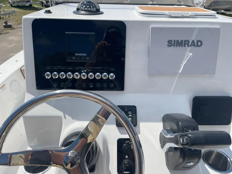 Slide: The Image of 2024 Sea Pro 202 CC boat with beige cushioned seating. - 9