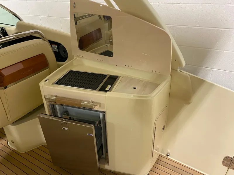 Slide: The Image of 2024 Chris-Craft LAUNCH GT 35 boat interior with kitchenette and seating. - 10