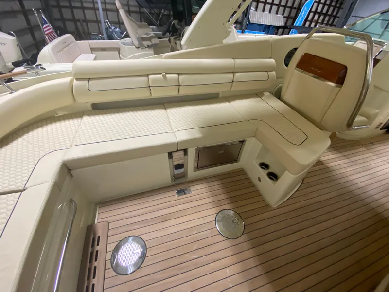 Slide: The Image of 2024 Chris-Craft LAUNCH GT 35 interior with beige seating and wooden flooring. - 11