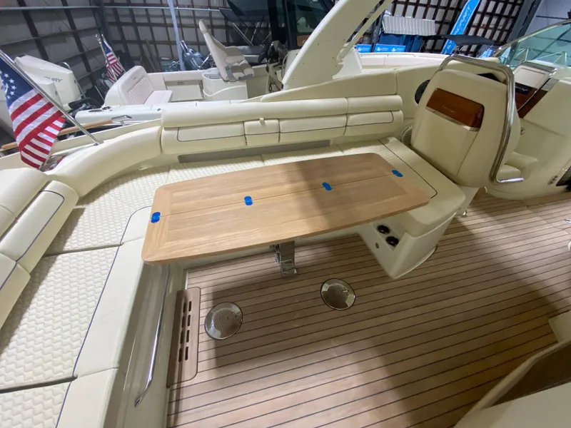 Slide: The Image of 2024 Chris-Craft LAUNCH GT 35 boat interior with wooden table and seating. - 12