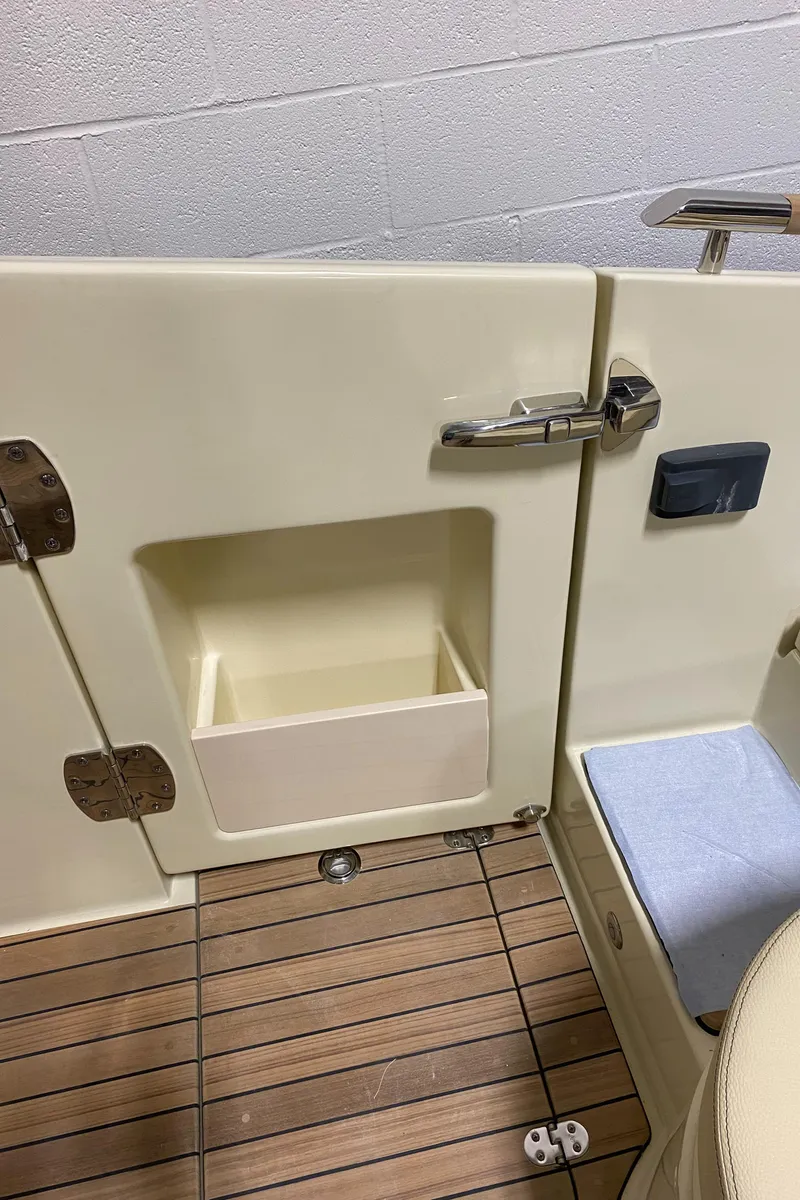 Slide: The Image of 2024 Chris-Craft LAUNCH GT 35 boat interior with storage compartment and wooden flooring. - 15