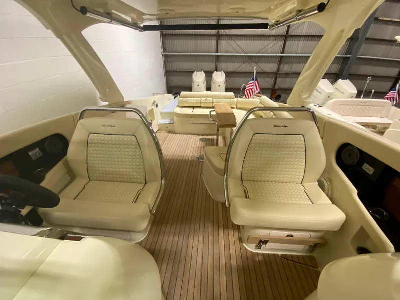 Slide: The Image of 2024 Chris-Craft LAUNCH GT 35 interior with luxurious seating and wooden deck. - 18