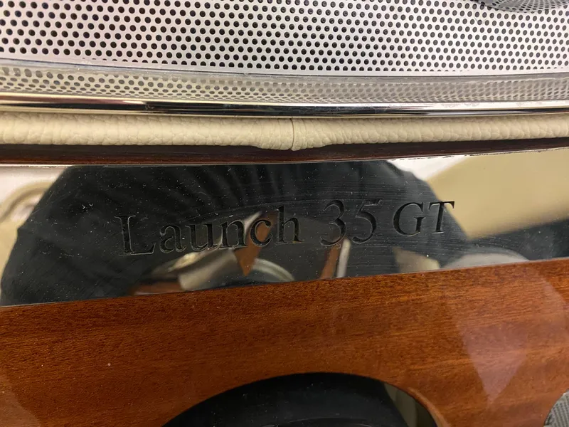 Slide: The Image of 2024 Chris-Craft Launch GT 35 nameplate on wooden panel. - 22