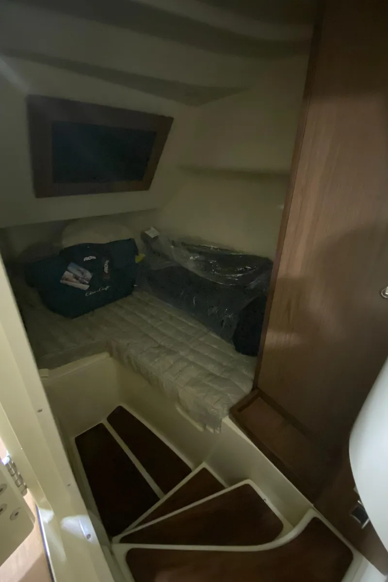 Slide: The Image of 2024 Chris-Craft LAUNCH GT 35 cabin interior with bed and wooden stairs. - 25