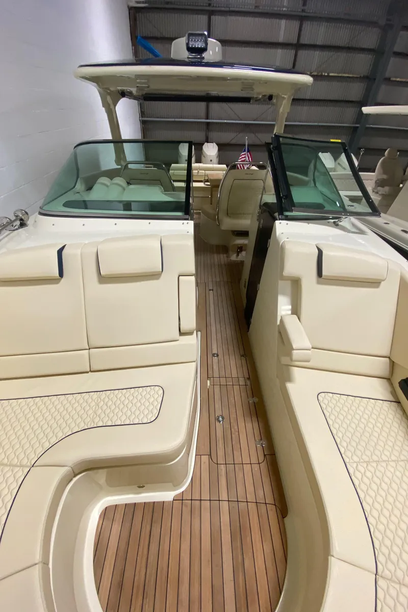 Slide: The Image of 2024 Chris-Craft LAUNCH GT 35 luxury boat interior with teak flooring and white seating. - 29