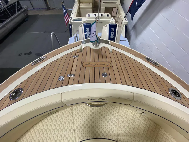 Slide: The Image of 2024 Chris-Craft LAUNCH GT 35 boat deck with teak flooring and dual outboard motors. - 30