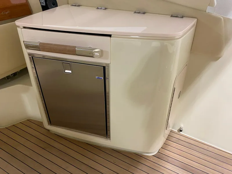 Slide: The Image of 2024 Chris-Craft LAUNCH GT 35 interior, featuring a compact stainless steel refrigerator. - 9