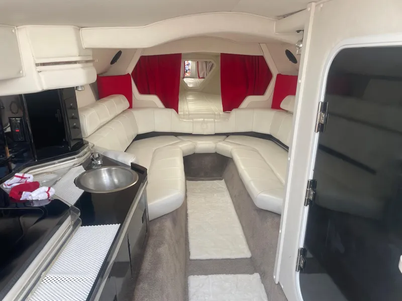 Slide: The Image of 1995 Fountain 42 Executioner boat interior with white leather seating and red curtains. - 16