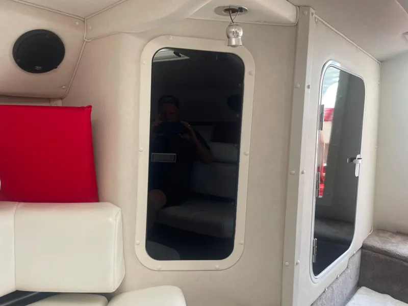 Slide: The Image of Interior of a 1995 Fountain 42 Executioner boat with white seating and mirrored door. - 20