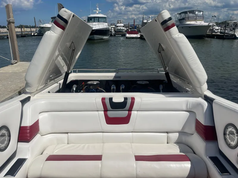Slide: The Image of 1995 Fountain 42 Executioner boat interior with open engine hatches at marina. - 27