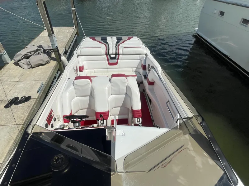 Slide: The Image of 1995 Fountain 42 Executioner speedboat docked, featuring white and red interior. - 3