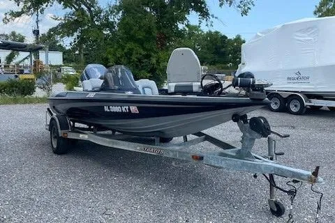 Slide: The Image of 2002 Stratos 17 XL boat on a trailer in a gravel lot. - 0
