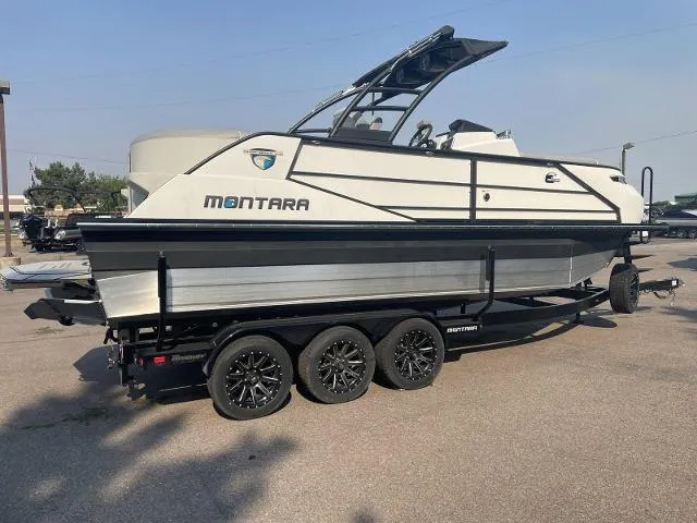 Slide: The Image of 2022 Montara Surf Boss 2.0 boat on a triple-axle trailer in a parking lot. - 5