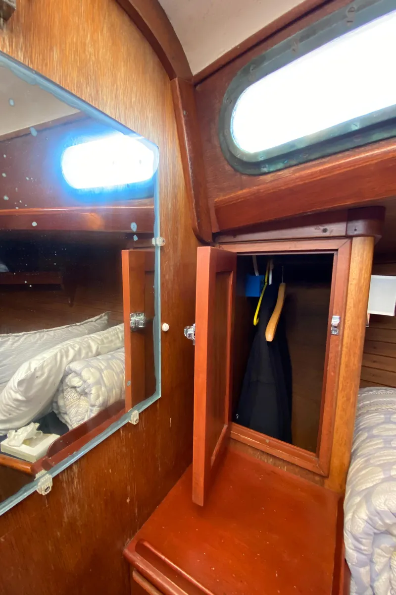 Slide: The Image of Hinckley Bermuda 40 sailboat interior with wooden cabinetry and mirror, 1962 model. - 12