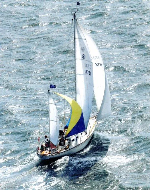 Slide: The Image of Hinckley Bermuda 40 sailboat from 1962 navigating through choppy waters. - 2