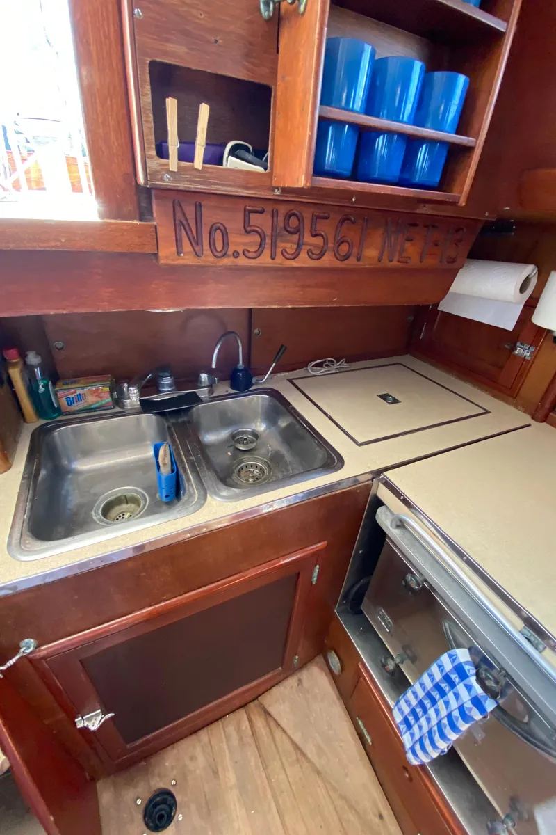 Slide: The Image of Galley of 1962 Hinckley Bermuda 40 sailboat with dual sinks and storage shelves. - 24