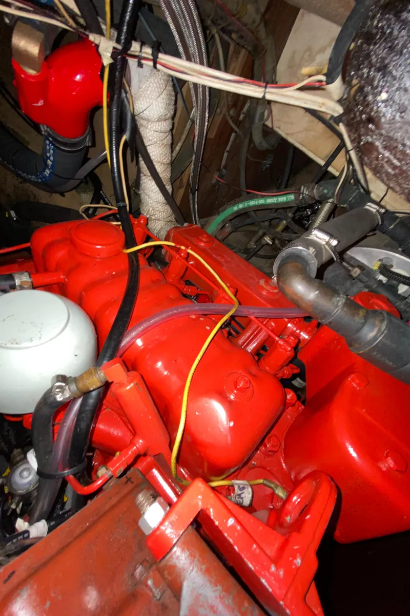 Slide: The Image of Red engine of a 1962 Hinckley Bermuda 40 sailboat with visible wiring and components. - 27
