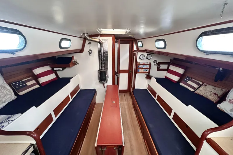 Slide: The Image of Interior of 1962 Hinckley Bermuda 40 sailboat with cozy seating and nautical decor. - 28