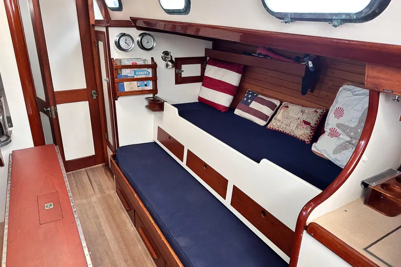 Slide: The Image of Interior of a 1962 Hinckley Bermuda 40 sailboat with cozy seating and nautical decor. - 29