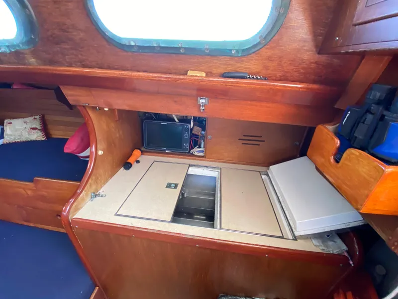 Slide: The Image of Interior of 1962 Hinckley Bermuda 40 sailboat with wooden cabinetry and storage compartments. - 3