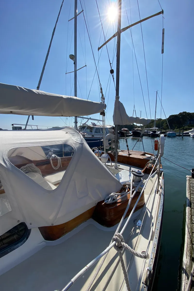 Slide: The Image of 1962 Hinckley Bermuda 40 sailboat docked under clear blue sky. - 5
