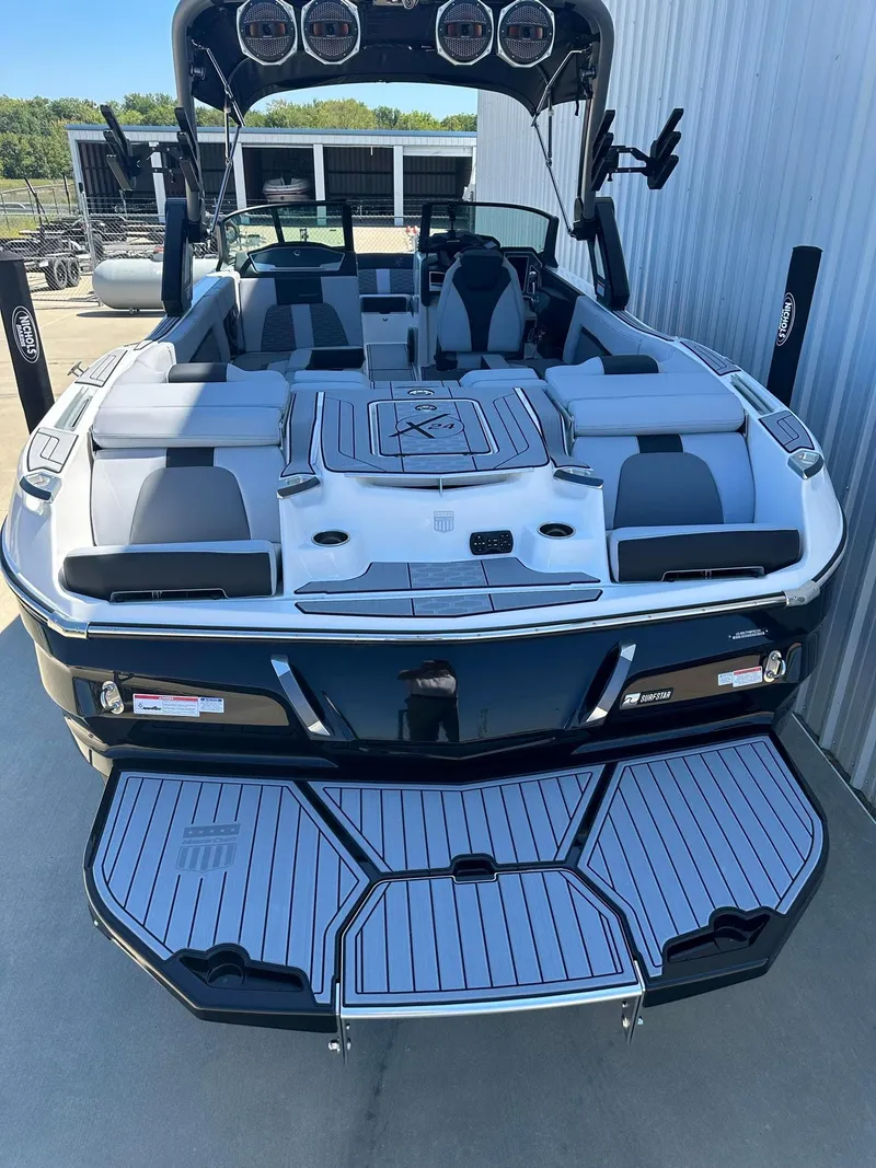 Slide: The Image of 2024 MasterCraft X24 boat with spacious seating and modern design. - 2