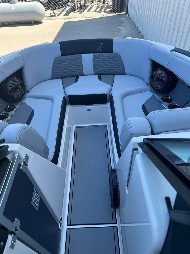 Slide: The Image of 2024 MasterCraft X24 boat interior with luxurious seating and modern design. - 7