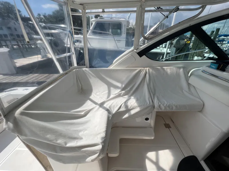 Slide: The Image of 2004 Tiara Yachts 3200 Open interior seating area with protective covers. - 10