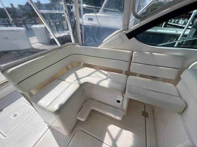Slide: The Image of 2004 Tiara Yachts 3200 Open interior seating area with white upholstery. - 12