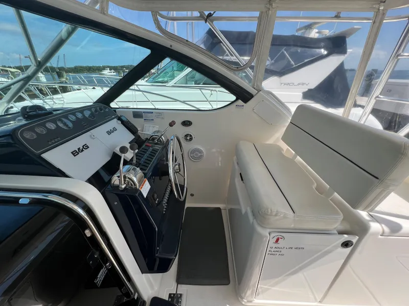 Slide: The Image of Helm station of a 2004 Tiara Yachts 3200 Open with seating and navigation equipment. - 14