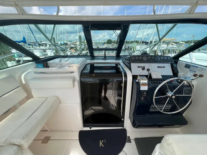 Slide: The Image of 2004 Tiara Yachts 3200 Open helm station with modern controls and panoramic view. - 16