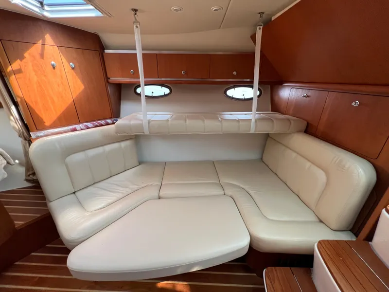 Slide: The Image of 2004 Tiara Yachts 3200 Open interior with cream leather seating and wooden cabinetry. - 22