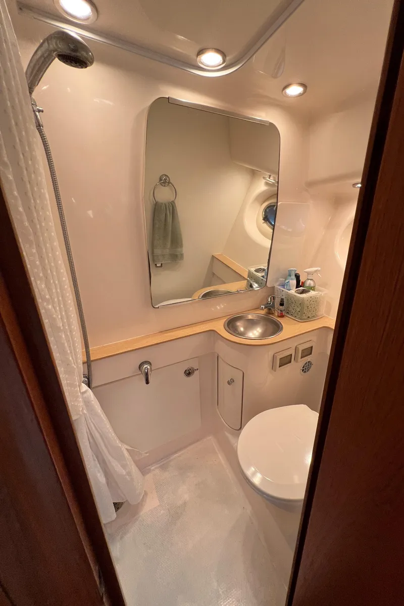Slide: The Image of 2004 Tiara Yachts 3200 Open bathroom with sink, mirror, and shower. - 26